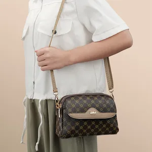 Stylish women's monogram crossbody bag with adjustable strap, compact daily shoulder handbag.