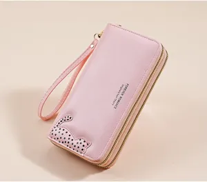 Detailed view of the pink long PU leather wallet featuring a cute cat pattern and wrist strap.