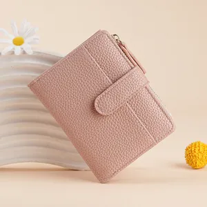 Pink leather women wallet detail, short bi-fold card holder with zipper coin pocket and button.