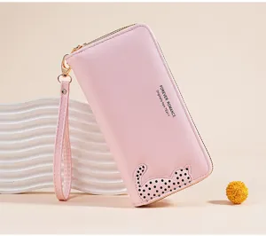 Pink long wallet for women with cute cat pattern, zipper closure, wrist strap, PU leather detail.