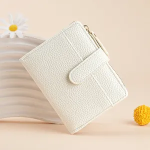 Close up of white short leather wallet details, multi card slots and zipper coin purse.