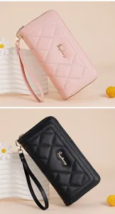 Detailed view of women long quilted wallet with wristlet, showing texture and hardware.
