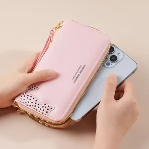 Pink long PU leather wallet for women with wrist strap, cat pattern and spacious design.