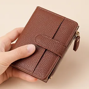 Brown leather short wallet detail, compact card holder with zipper coin pocket and snap closure.
