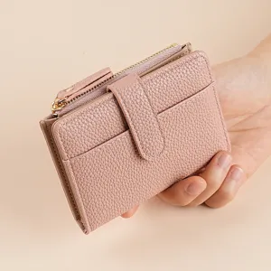 Pink women's short two-fold leather wallet with zipper coin purse and multiple card slots.