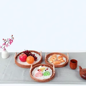 Detailed view of round woven wicker tray with handles, ideal for cozy home tea and fruit styling.