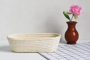 Detail shot of oval rattan bread proofing banneton basket placed on clean tabletop setup.