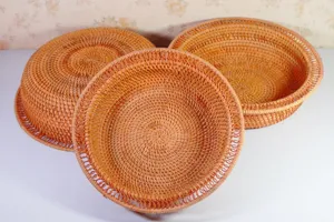 Detailed view of handmade woven rattan round baskets, perfect for home fruit and snack storage.