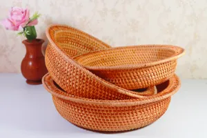 Detailed view of handmade woven rattan fruit basket, natural storage tray for home decoration.
