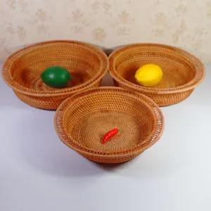 Set of 3 round woven rattan fruit baskets, handmade storage trays for home kitchen use.