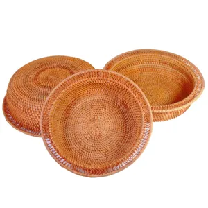 Handcrafted Vietnamese rattan woven fruit basket, round storage tray for home living room snacks.