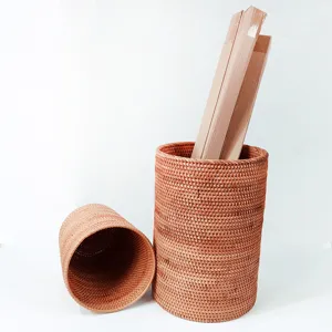 Detail view of the natural rattan woven storage bucket, showcasing fine handmade texture.