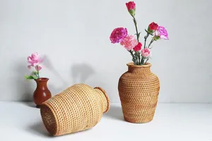 Detailed shot of Nordic style hand-woven rattan vase and tabletop home decor setup