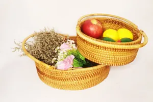 Close-up of woven rattan storage baskets set with artificial flowers and fruits for home decor