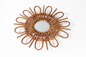 Detailed shot of the handcrafted round rattan decorative mirror, perfect for boho home decor.