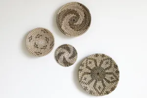 Close-up of handmade woven wall hanging plates featuring natural seagrass pattern details.
