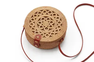 Round woven rattan straw crossbody bag detail, vintage bohemian boho style shoulder bag.