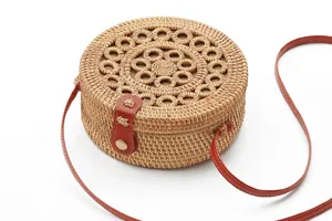 Handmade round rattan crossbody straw bag with leather strap for women summer beach style detail.