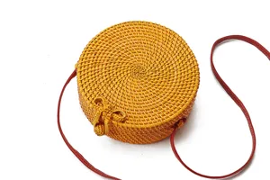 Round rattan woven shoulder bag detail view with red strap for daily use summer beach vacation