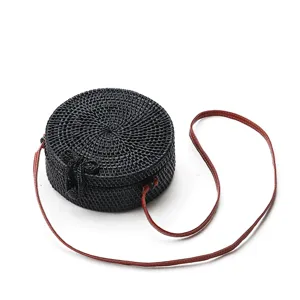Black round rattan straw crossbody bag for women with brown leather strap for summer.