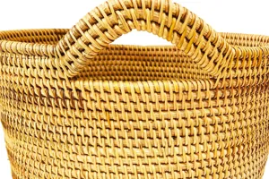 Gros plan sur la texture détaillée du panier de rangement en rotin tissé à la main.