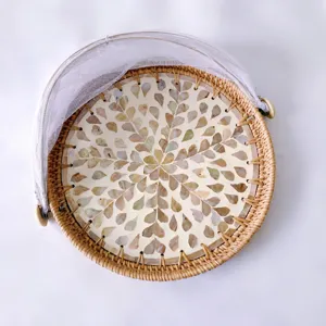 Handmade woven rattan fruit basket with shell inlay and mesh cover for home daily use.