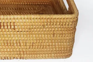 Detailed view of handmade woven rattan storage basket, showing fine natural wicker texture.