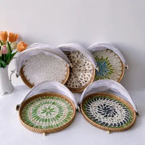 Close-up detail of handcrafted rattan woven fruit basket with colorful shell mosaic and mesh.