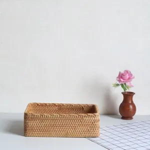 Close-up detail of natural woven rectangular rattan storage basket with neat texture.