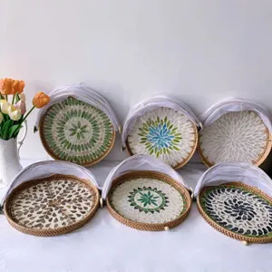 Handcrafted rattan fruit basket with colorful shell mosaic and mesh cover for home use.