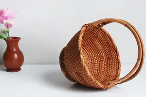 Detailed close-up of handmade rattan fruit basket with handle for desktop home decor.