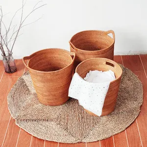 Detail view of woven rattan storage baskets set on straw mat for home decor and laundry.