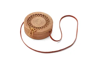 Round woven rattan shoulder bag with cute bow detail, perfect boho style for summer beach.