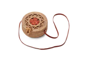 Close-up view of the round rattan straw bag showing exquisite hand-woven texture and details.