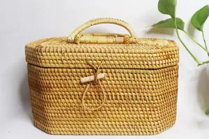 Handmade rattan storage box detail, natural wicker organizer with lid and handle for use.