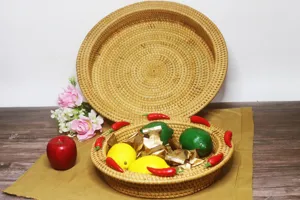 Detailed view of handmade woven rattan candy tray and fruit storage basket with fruit props.