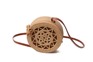 Round rattan straw bag with bow and leather strap, perfect Bali beach shoulder handbag.
