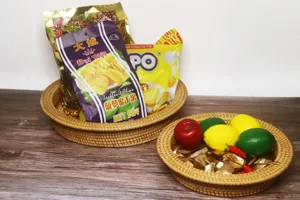 Detailed shot of Vietnamese handmade woven rattan storage basket and fruit plate for home snacks.