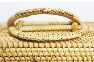 Close-up detail of handmade rattan woven storage box lid with exquisite craftsmanship texture.