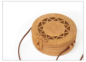 Gedetailleerde close-up van een handgemaakte ronde gevlochten rattan schoudertas.