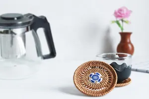 Handmade rattan woven cup coaster with ceramic center, heat resistant teapot mat for home kitchen.