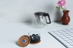 Handcrafted rattan woven tea cup mat detail view with blue and white porcelain decor for home table.