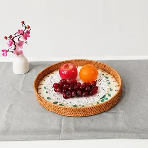 Nordic style handmade rattan serving tray with shell inlay, round fruit basket detail view.