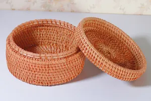 Detailed view of round woven rattan storage box with lid, perfect for desktop organization.