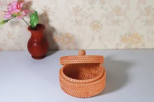 Vietnamese round rattan storage box with lid for desktop sundries and nuts organization.