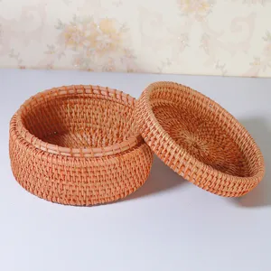 Vietnamese round woven rattan storage box with lid, natural handmade desktop organizer.