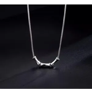 Close-up detail of the titanium steel bamboo joint necklace showing delicate chain and pendant craftsmanship.