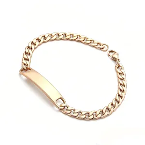 Close-up detail of men gold stainless steel Cuban chain ID bracelet links surface.