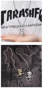 Detailed view of stylish hip-hop robot pendant necklace for men and women couple streetwear.