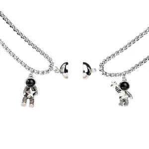 Magnetic couple necklaces with astronaut pendants, matching silver chain jewelry gifts.